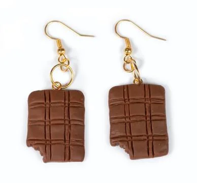 Earrings in the form of chocolates Stock Photos