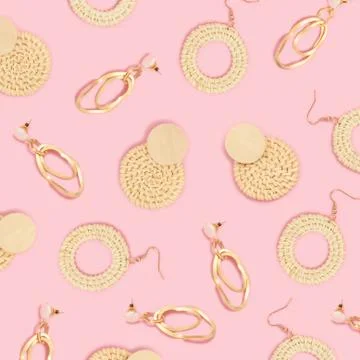 Earrings pattern on a pink pastel background. Stock Photos
