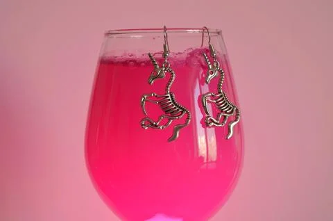 Earrings on a pink background Stock Photos