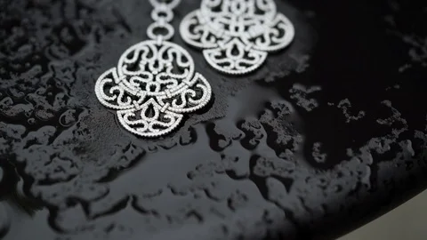 Earrings on wet table Stock Footage 72717291