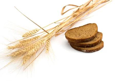Ears of wheat and the cut bread Stock Photos
