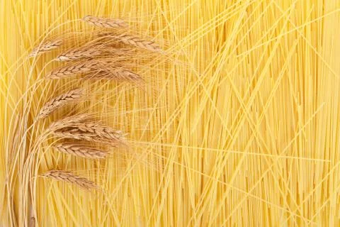 Ears of wheat on a background scattered spaghetti Stock Photos