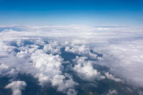 Earth in the airplane window with clouds Stock Photos