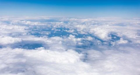 Earth in the airplane window with clouds Stock Photos