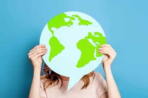 Earth day concept. Ecological problems of the globe, planet. Girl holding pos Stock Photos