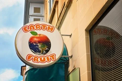 Earth Fruit Store Sign with Creative Apple and Planet Logo Stock Photos