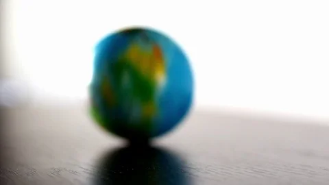 Earth Globe Ball Rolling In And Out Of Frame Video stock 70006448