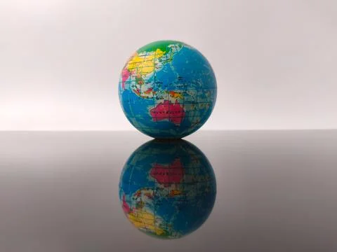 Earth globe with reflection on a white background Stock Photos