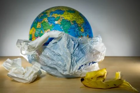 Earth inside a plastic and some garbage like paper and banana leftovers. Eart Foto stock