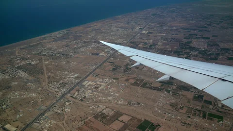 Earth land tiny city from top view airplane wing side during landing take off Stock Footage 255369573