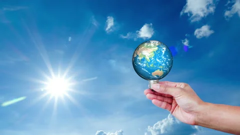 The earth in a light bulb on cloud sky time lapse. green energy for environment  Stock Footage 146053792