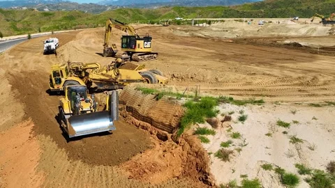 Earth mover grading dirt dumping earth and earth, bulldozer Caterpillar backhoe Stock Footage 274763285