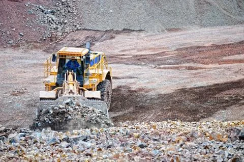 Earth mover loading rocks in a quarry Stock Photos