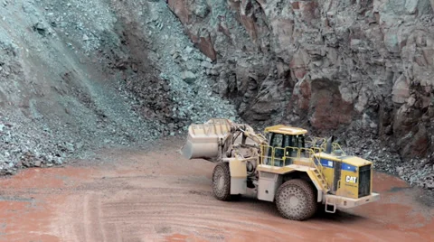 Earth mover ready to loading a dumper truck in a quarry 스톡 동영상 37498968