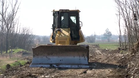 Earth movers leveling ground on road construction in field. Stock Footage 234207042