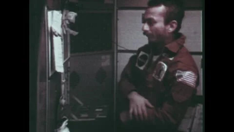 EARTH ORBIT - 1973: Seated operator — Skylab 3 immunology work station Stock Footage 348025342