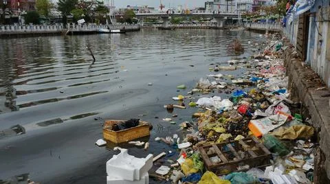 Earth Pollution Garbage Thrown Into The River Stock Photos