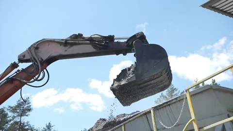 Earth is poured from the bucket of the escalator Stock Footage 276214804