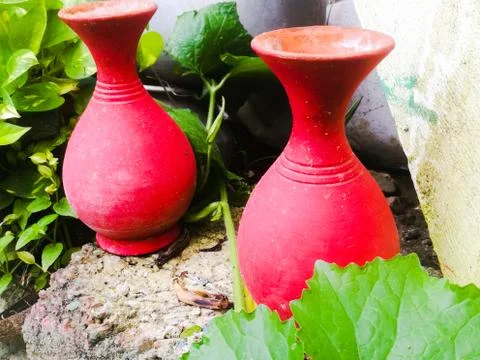 Earthen pots placed side by side for flowers placed in a garden. Stock Photos
