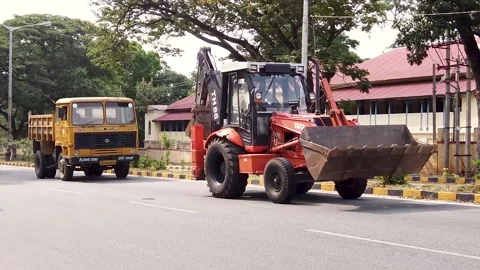 An Earthmoving JCB Machine moving in slow motion in Mysuru, India. Stock Footage 153961259