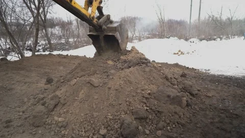 An earthmoving machine digs a hole at a construction site Video stock 148635052