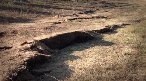 Earthquake shakes and rips cracks in the ground Stock Footage