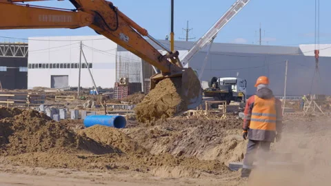 Earthwork at a construction, excavator dig a place for a foundation Stock Footage 161955375