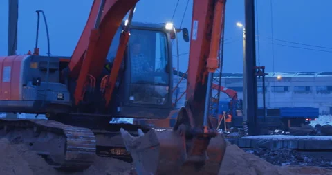 Earthwork at a construction site , an excavator digs a place for a foundation Stock Footage 147630866