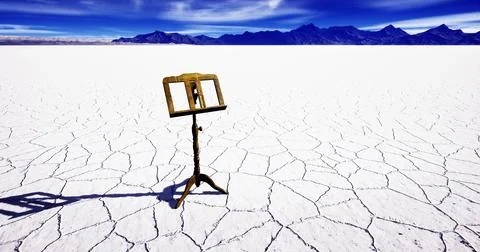 Easel alone on a salt flat with mountains under a blue sky Stock Illustration