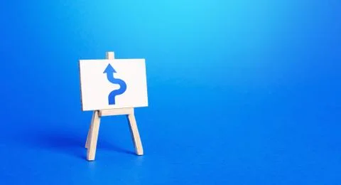 An easel with a blue arrow avoiding an obstacle. Maneuvering, taking right ac 写真素材