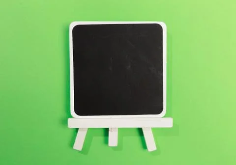 Easel with frames empty for drawing on colored background. Stock Photos
