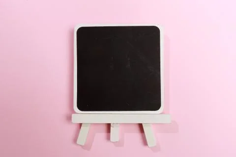Easel with frames empty for drawing on colored background. Stock Photos