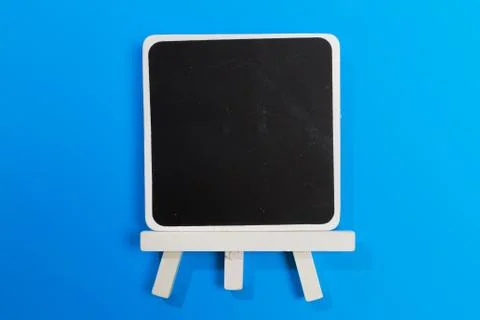 Easel with frames empty for drawing on colored background. Stock Photos