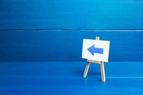 Easel with a left arrow. Sign of direction pointer. Hint, help in navigatio.. Stock Photos
