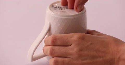 Easily taking a sticker off of a mug 1 스톡 동영상 132210682