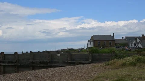 East facing view of the beach and groynes in Whitstable, Kent Stock Footage 277293453