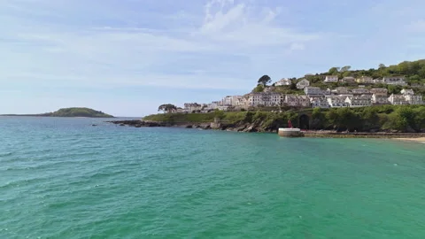 East Looe in Cornwall aerial drone shot flying backwards Pier beach Stock Footage 130575163
