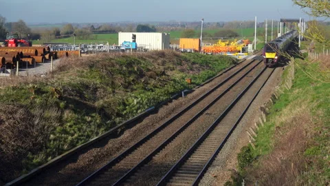An East Midlands train passing a construction site the Midland mainline railway Stock Footage 172302031