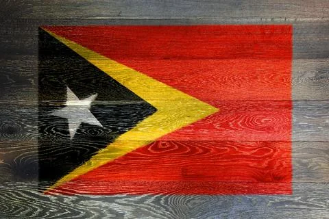 East Timor flag on rustic old wood surface background Stock Photos