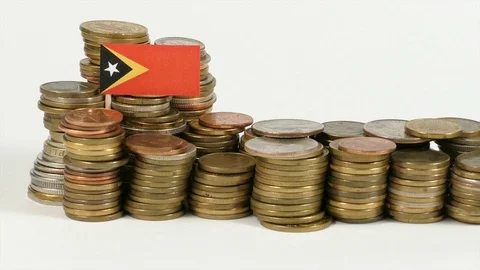East Timor flag waving with stack of money coins Video stock 71940228