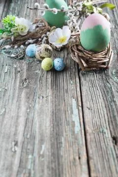 Easter and spirng composition. Easter eggs, willow twigs on rustic wooden bac Stock Photos