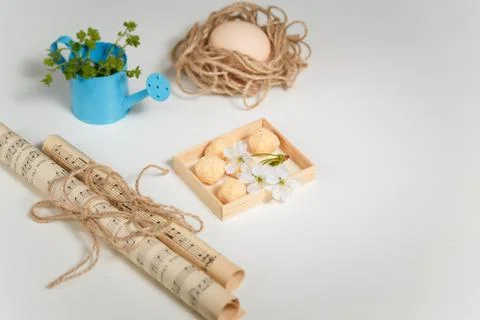 Easter and spring concept. Blue watering can with green grass, hen egg Stock Photos