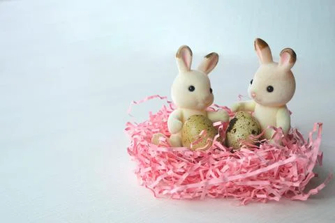Easter atmospheric composition with eggs and hares in the nest. Stock Photos