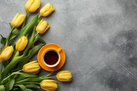 Easter background with blue, green eggs and a cup of tea in nest and yellow t Stock Photos