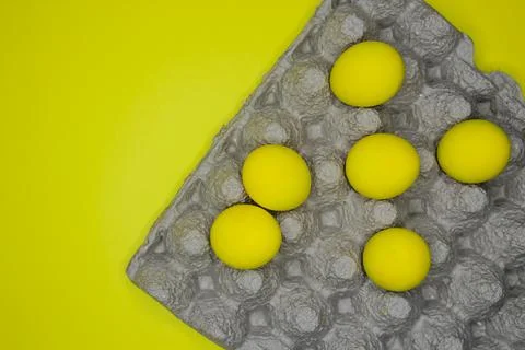 Easter background with bright yellow eggs Stock Photos