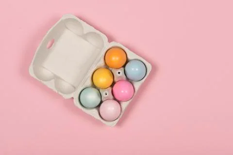 Easter background with a carton egg box with pastel colored easter eggs in it Stock Photos