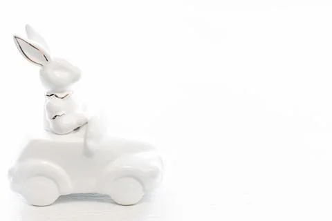 Easter background with a ceramic hare in the car. Stock Photos