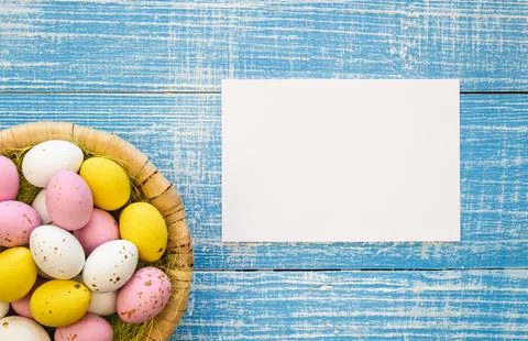 Easter background with chocolate eggs and a blank paper, flat lay, copy space. Stock Photos