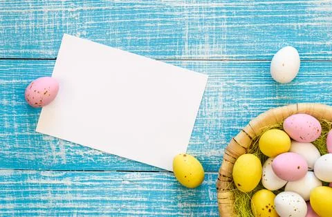 Easter background with chocolate eggs and a blank paper, flat lay, copy space. Stock Photos