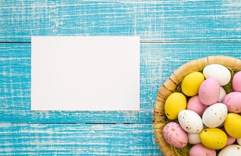 Easter background with chocolate eggs and a blank paper, flat lay, copy space. Stock Photos